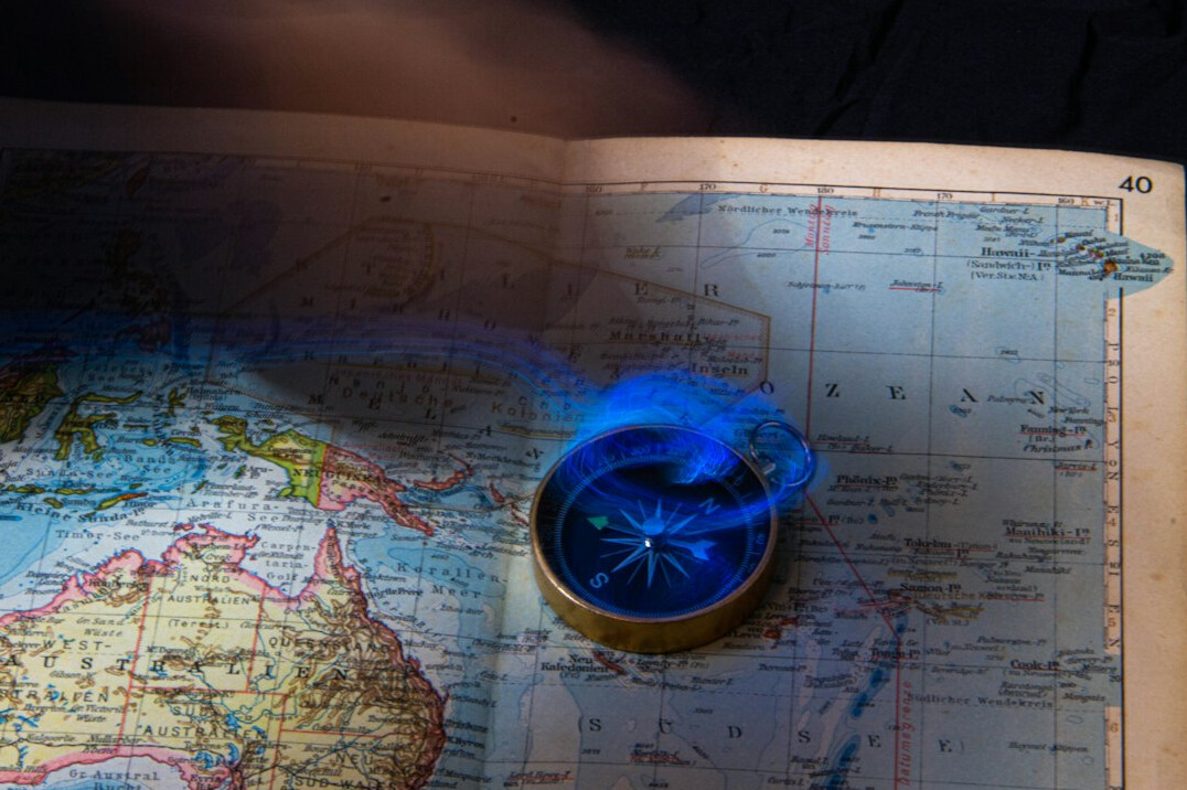 Compass resting on an old map symbolizing vision and direction