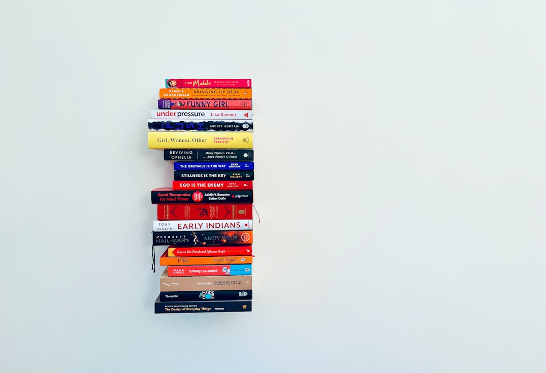 Stack of books symbolizing governance and ethical leadership knowledge